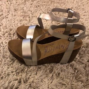 Silver strapped blowfish wedges